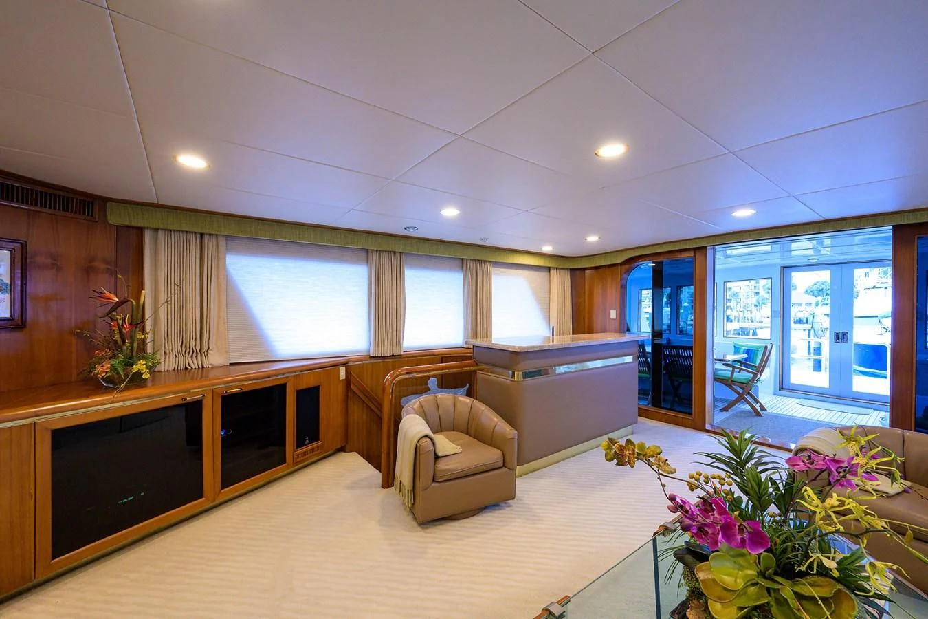 a large living room with a kitchen and dining area aboard ARIES Yacht for Sale
