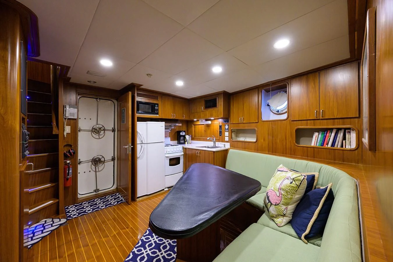 a living room with a couch and a table aboard ARIES Yacht for Sale