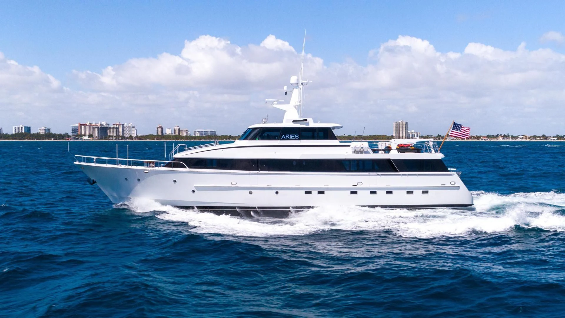 a white yacht in the water aboard ARIES Yacht for Sale