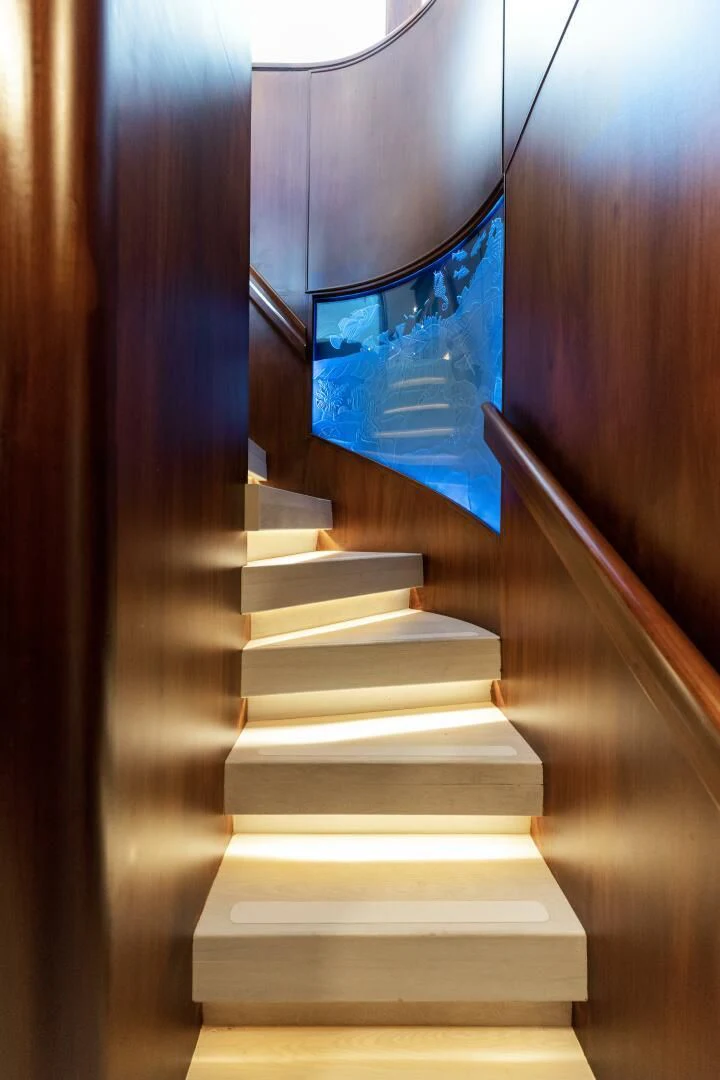 a staircase with a blue sign on it aboard ARIES Yacht for Sale