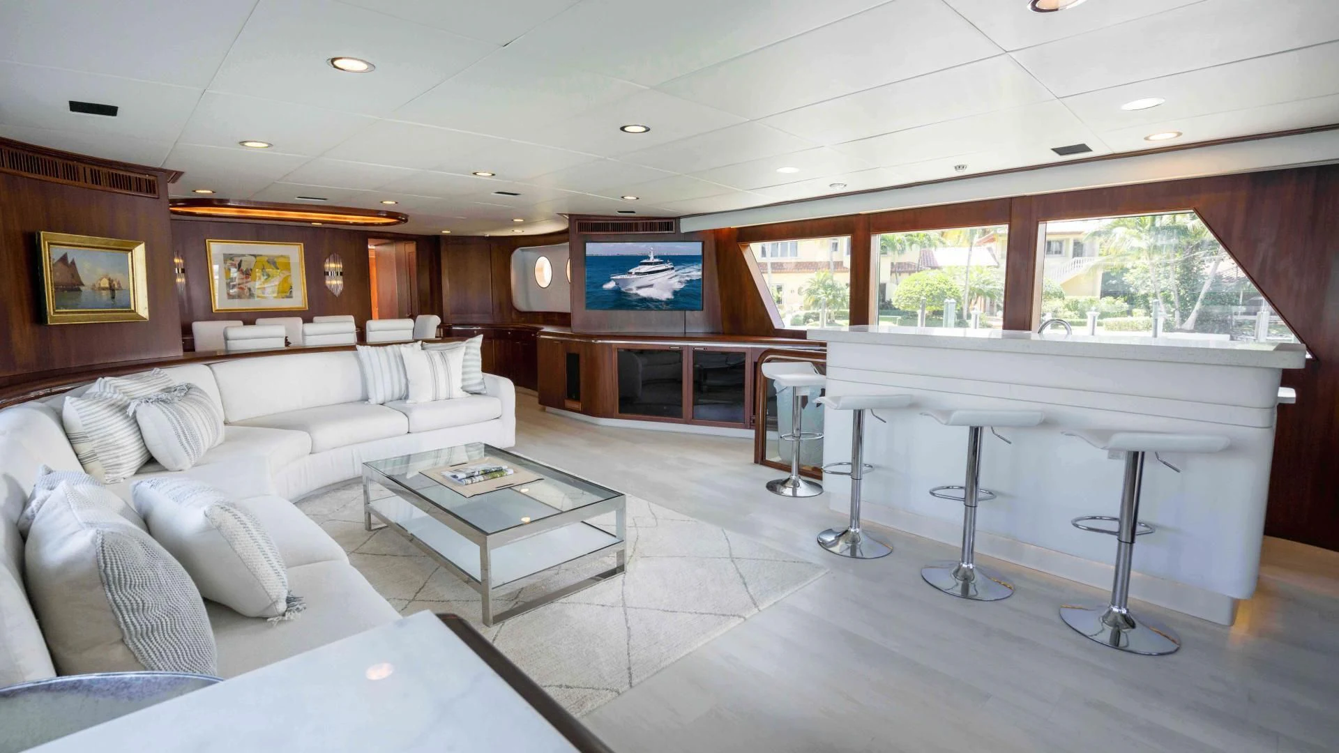 a living room with a large white sofa and a coffee table aboard ARIES Yacht for Sale