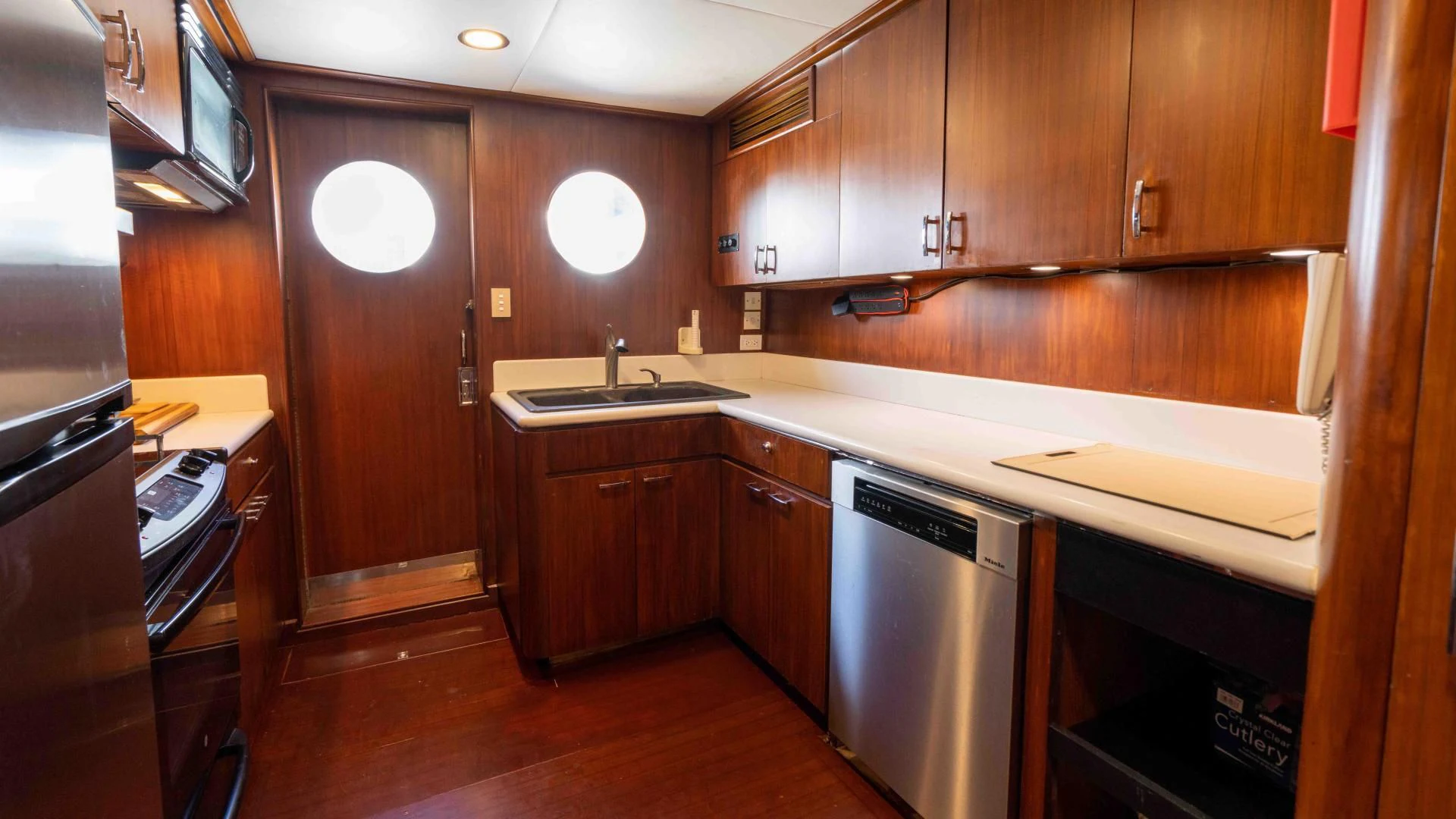 a kitchen with wooden cabinets aboard ARIES Yacht for Sale