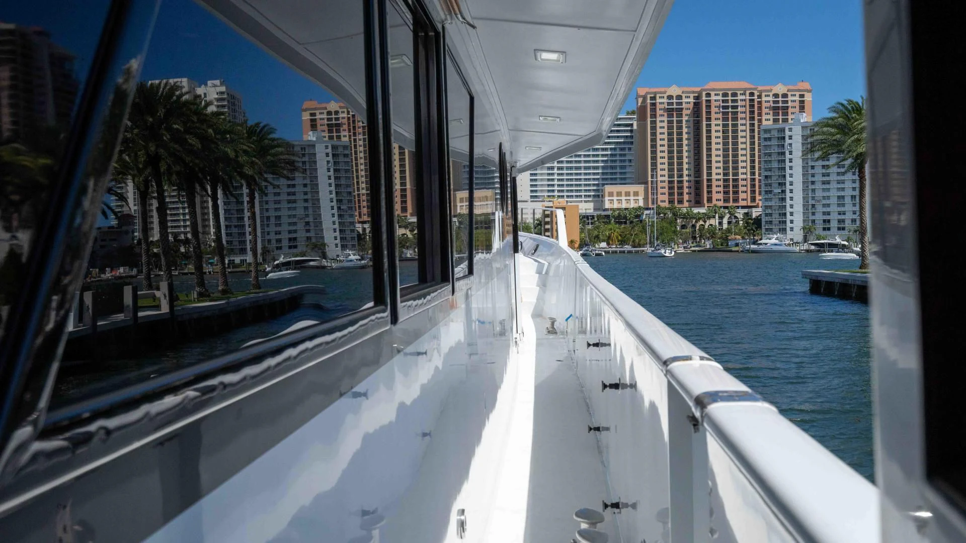 a large white boat in a body of water with buildings in the background aboard ARIES Yacht for Sale