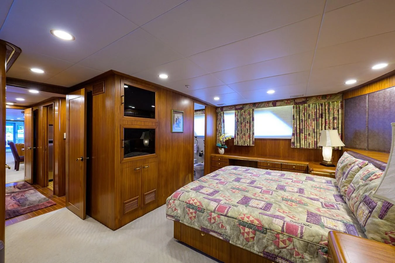 a bedroom with a bed and a tv aboard ARIES Yacht for Sale