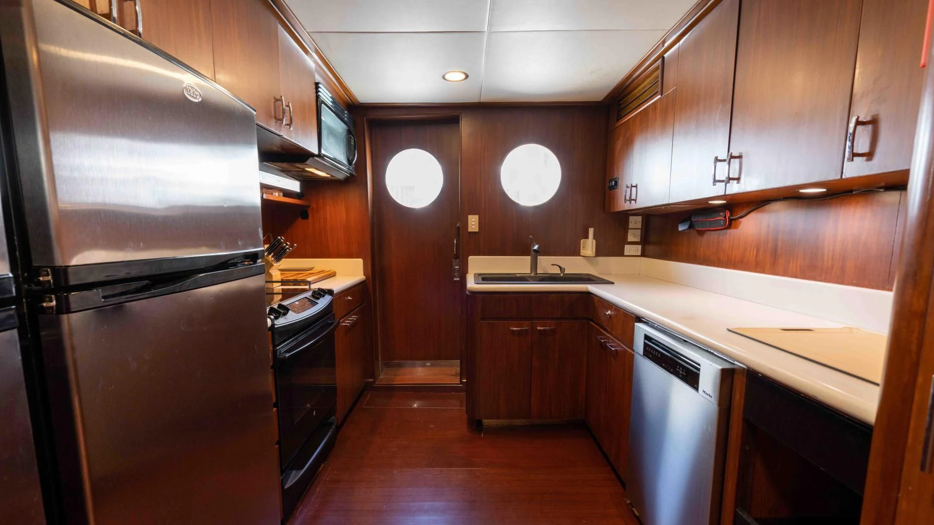 a kitchen with wooden cabinets aboard ARIES Yacht for Sale