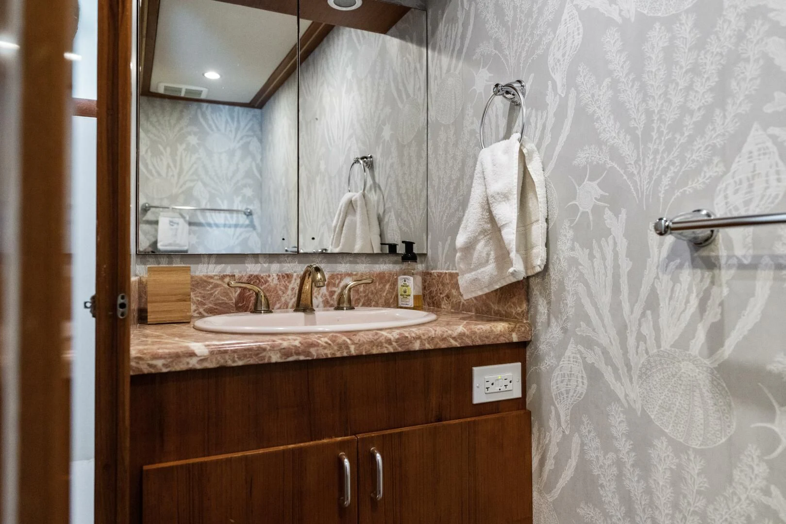 a bathroom with a large mirror aboard ARIES Yacht for Sale