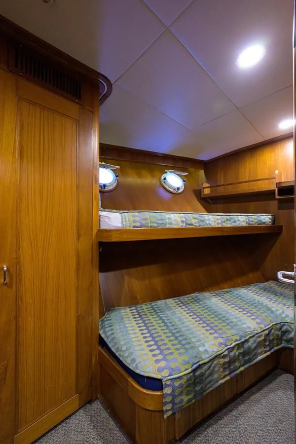 a room with bunk beds aboard ARIES Yacht for Sale