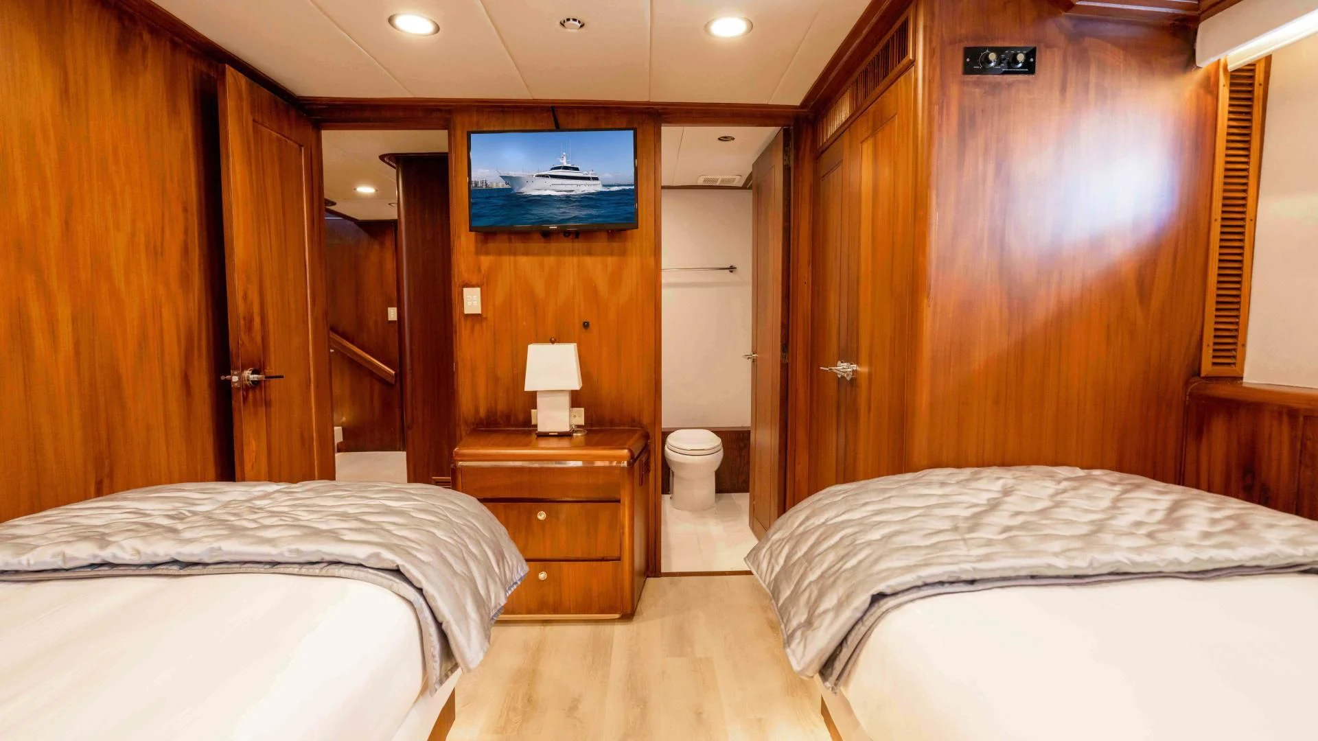 a room with a bed and a television aboard ARIES Yacht for Sale