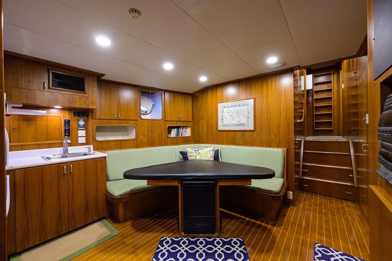 a room with a table and chairs aboard ARIES Yacht for Sale