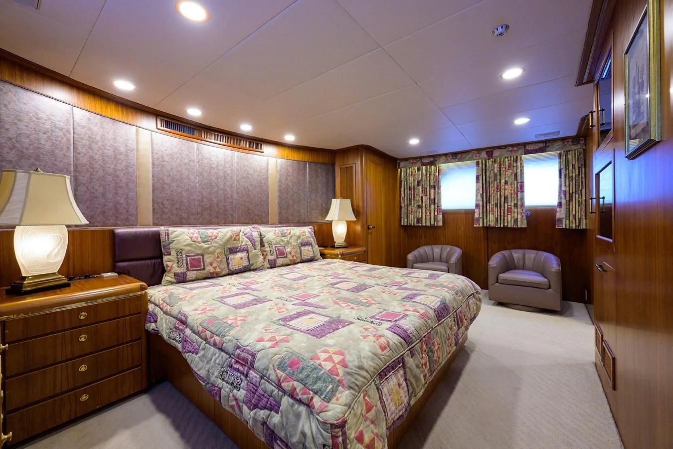 a bedroom with a bed and a chair aboard ARIES Yacht for Sale