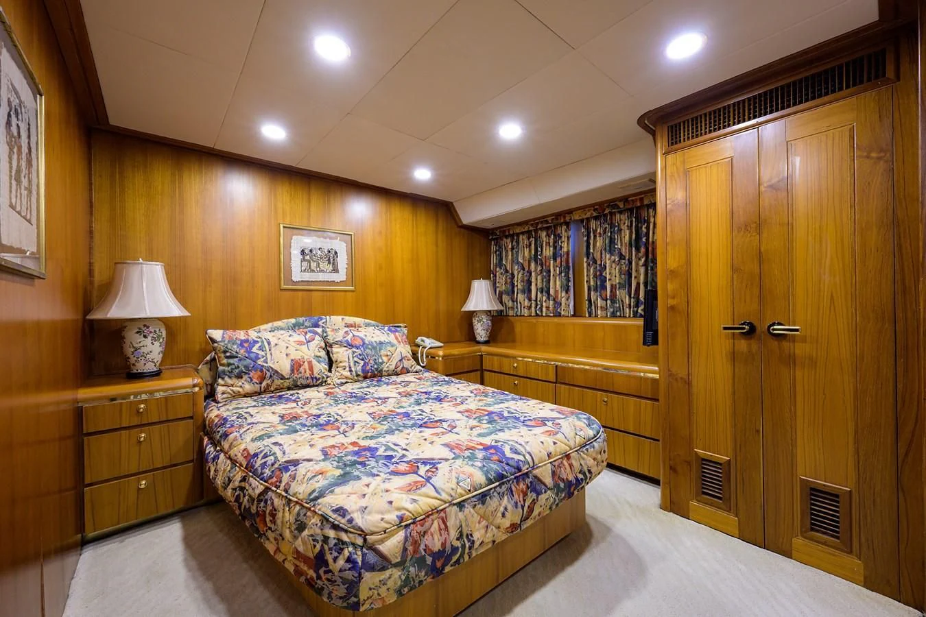 a bedroom with a bed and a closet aboard ARIES Yacht for Sale