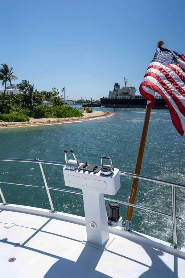 a boat with a flag on it aboard ARIES Yacht for Sale