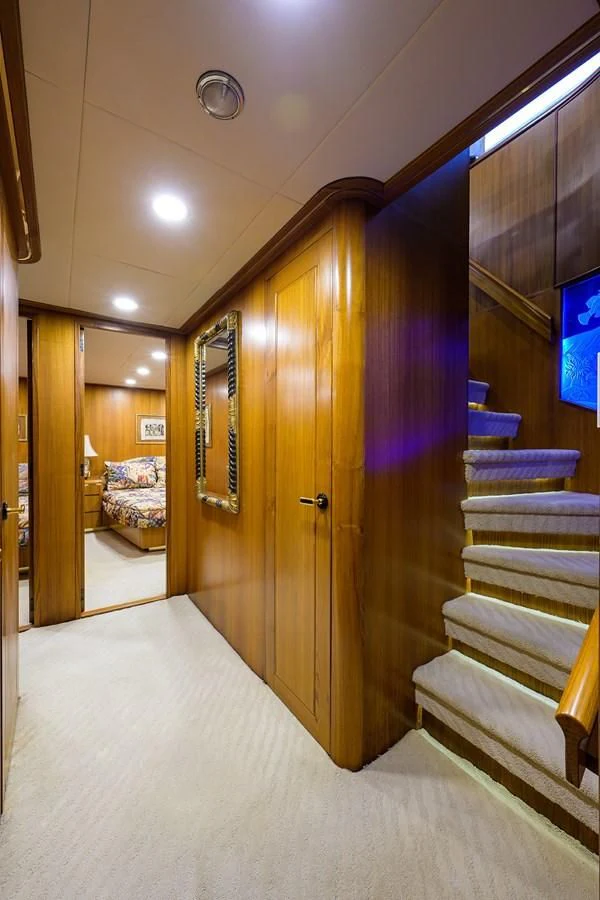 a hallway with a bed and a door aboard ARIES Yacht for Sale