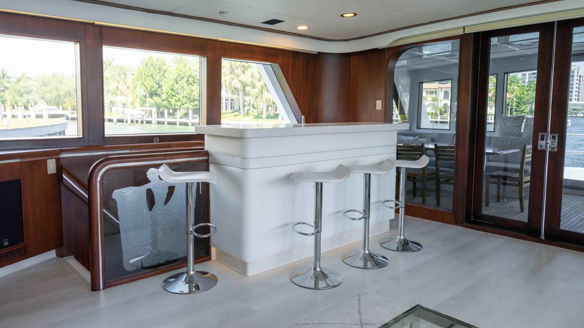 a white table and chairs in a room with wood walls aboard ARIES Yacht for Sale