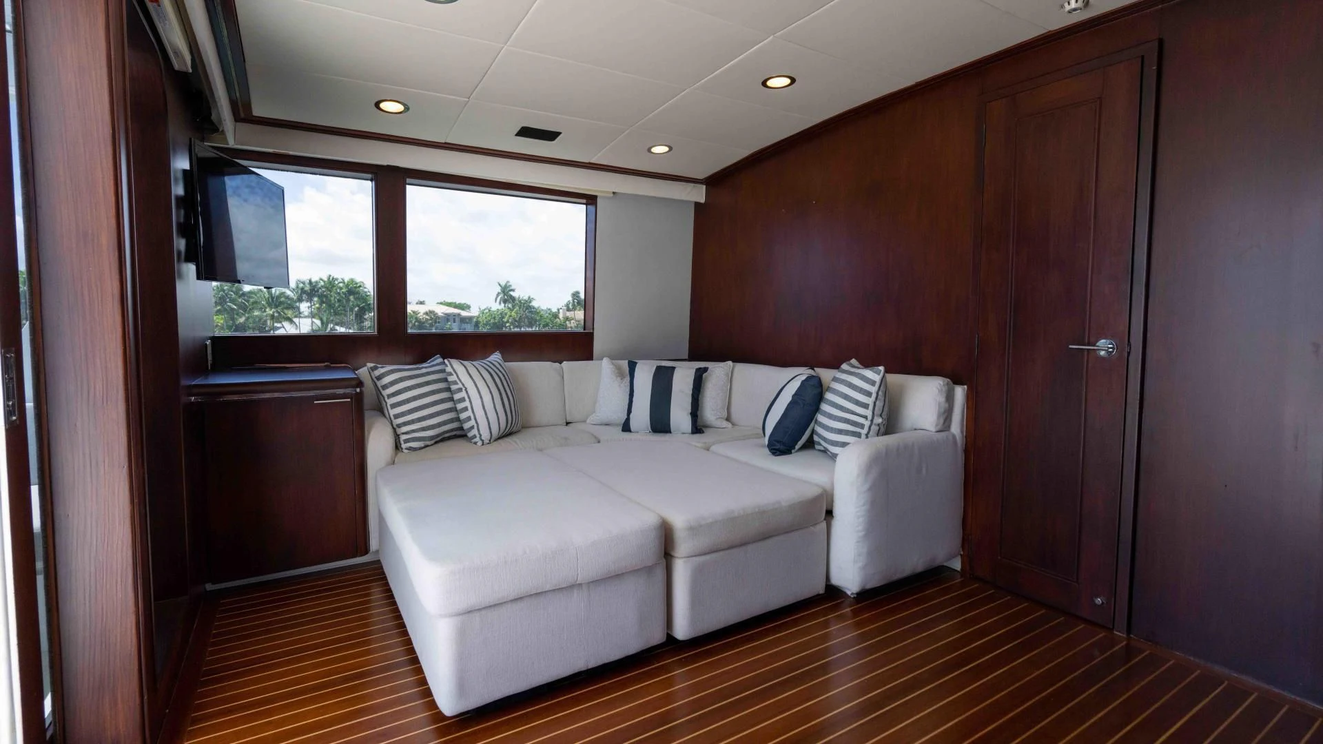 a room with a couch and a wood door aboard ARIES Yacht for Sale