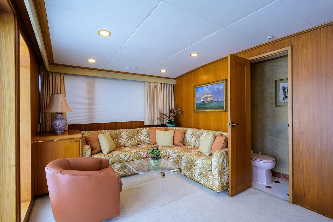a living room with a couch and a large mirror aboard ARIES Yacht for Sale