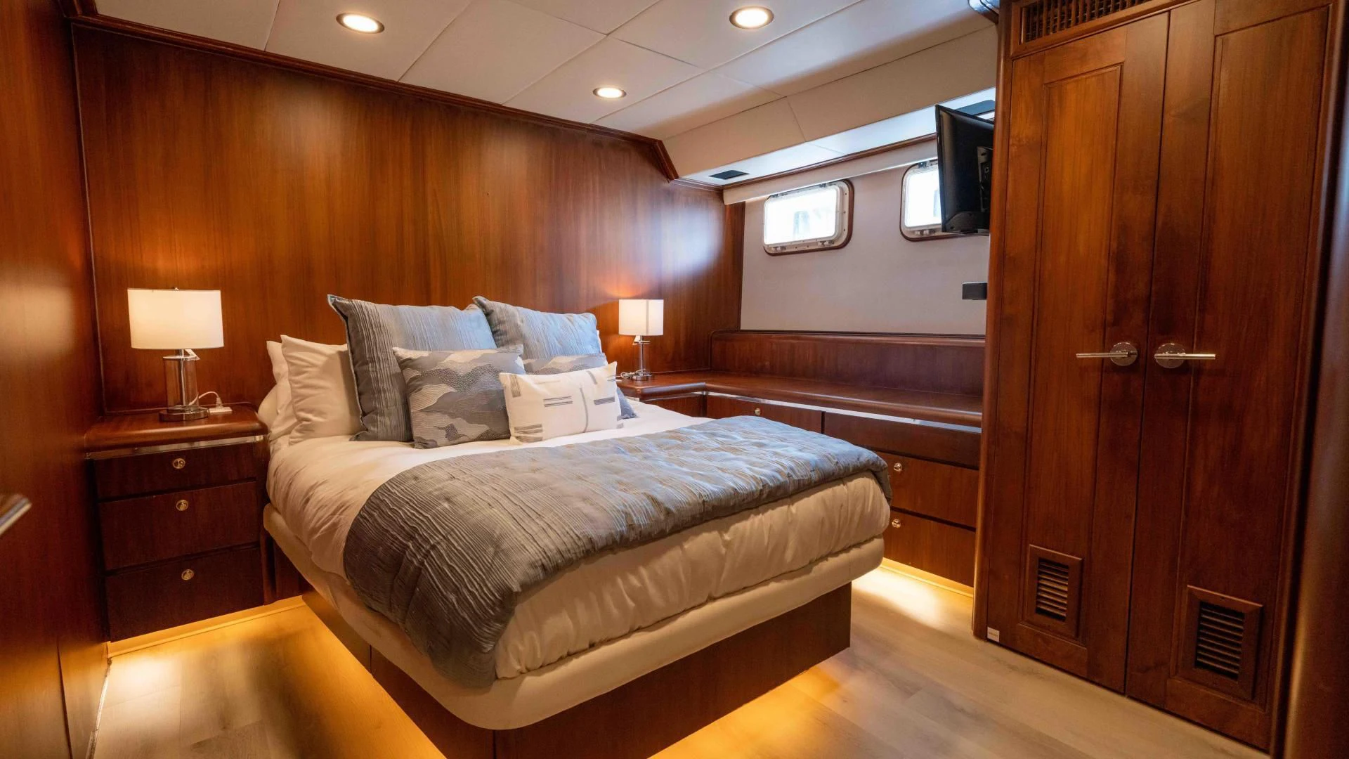 a bedroom with a bed and a desk aboard ARIES Yacht for Sale