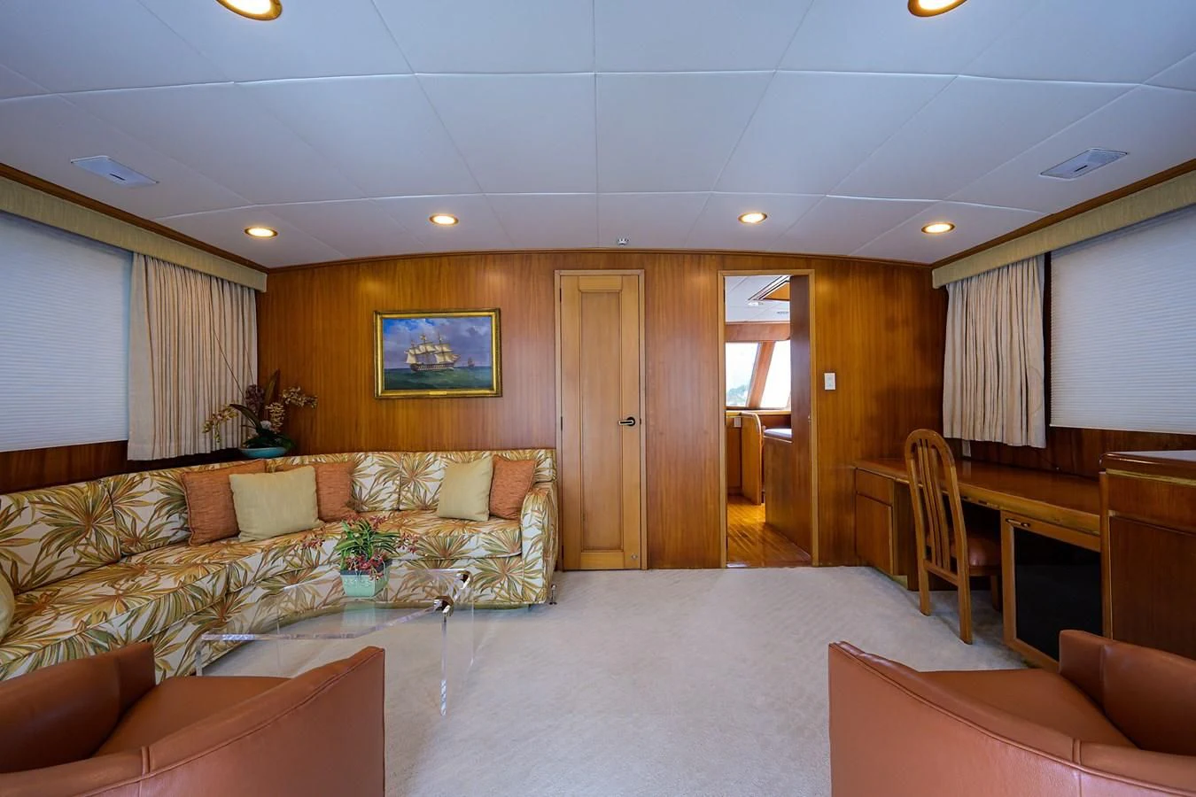 a large living room with a large white bed and a large window aboard ARIES Yacht for Sale