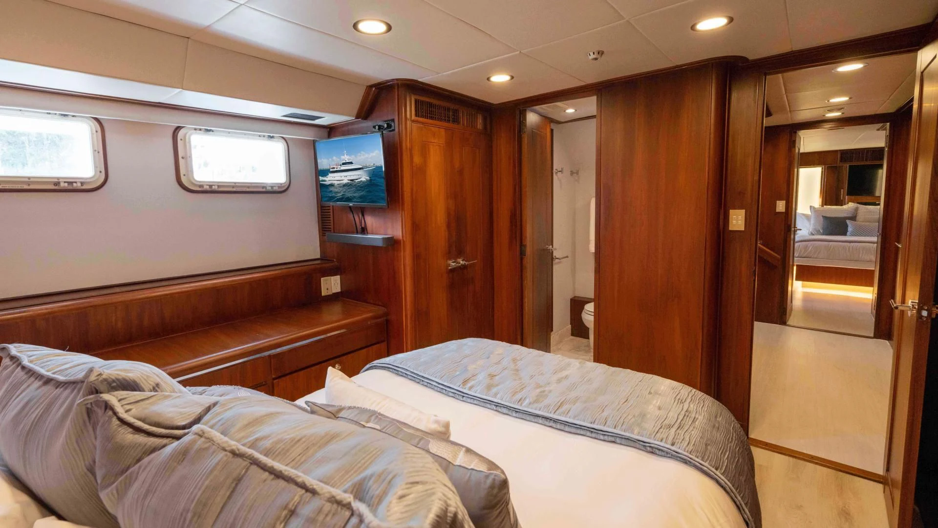 a room with a bed and a television aboard ARIES Yacht for Sale