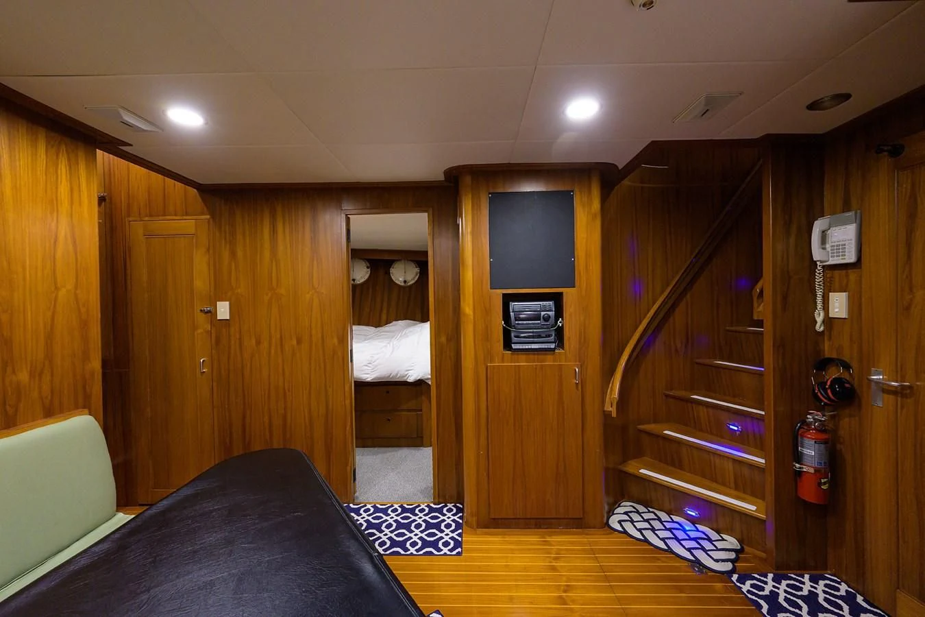a bedroom with a bed and a tv aboard ARIES Yacht for Sale