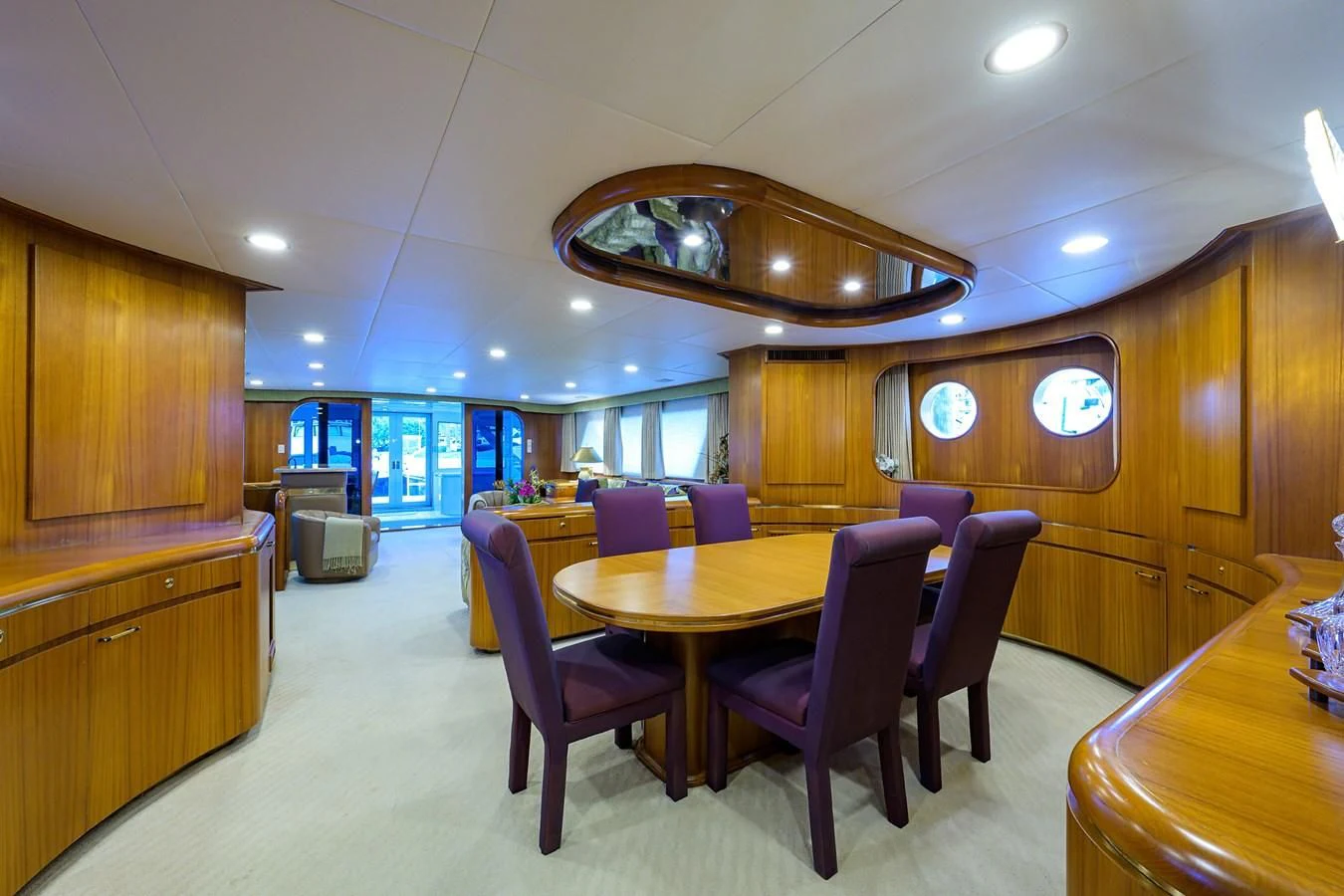 a large room with a table and chairs aboard ARIES Yacht for Sale