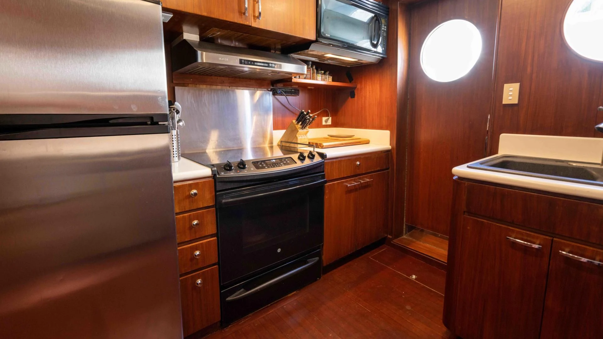 a kitchen with wooden cabinets aboard ARIES Yacht for Sale