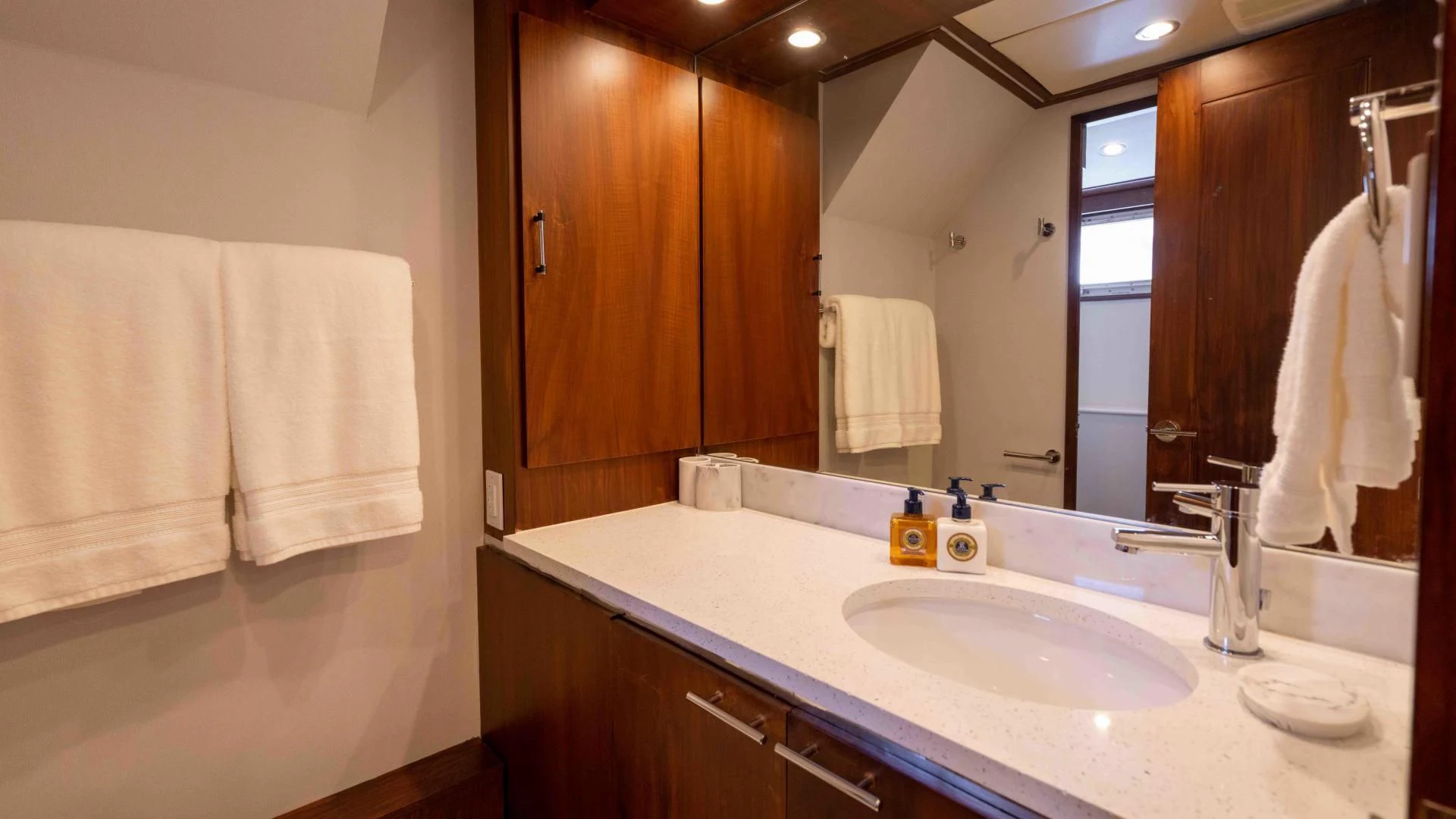 a bathroom with a large mirror aboard ARIES Yacht for Sale