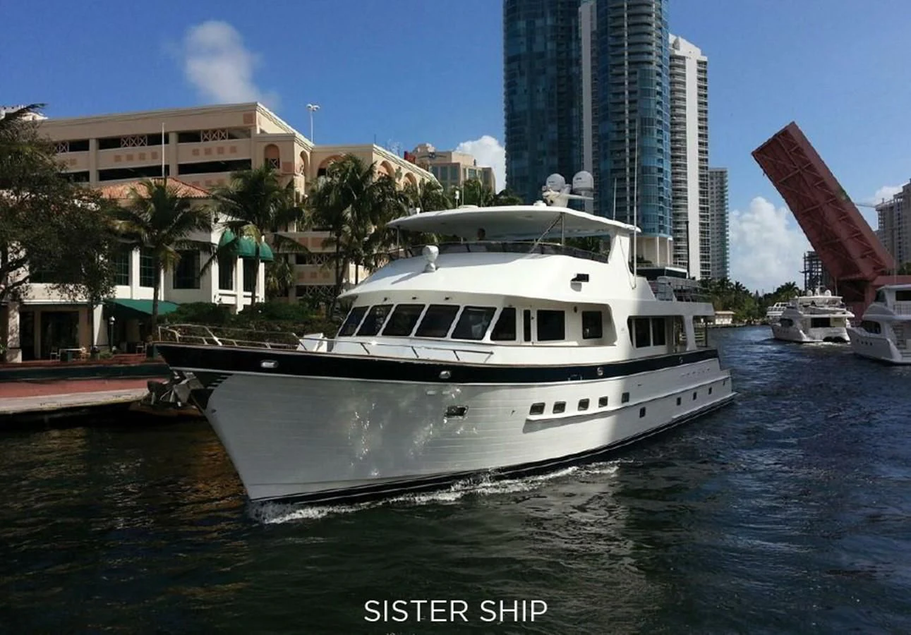 a white boat in a harbor aboard 860 MY Yacht for Sale