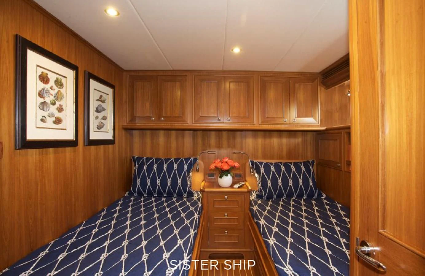 a bedroom with a blue and white bed spread aboard 860 MY Yacht for Sale