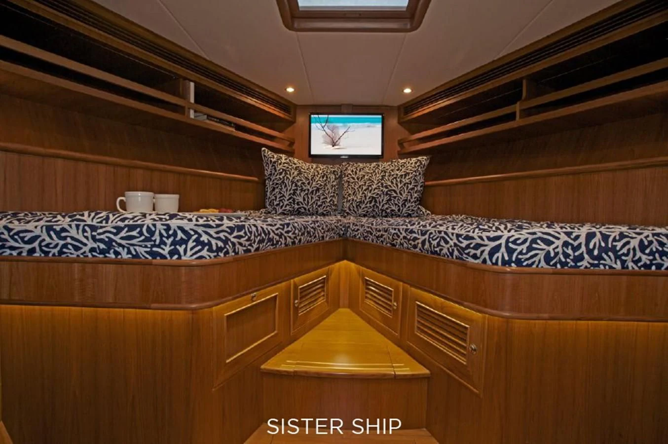 a room with a bed and a television aboard 860 MY Yacht for Sale