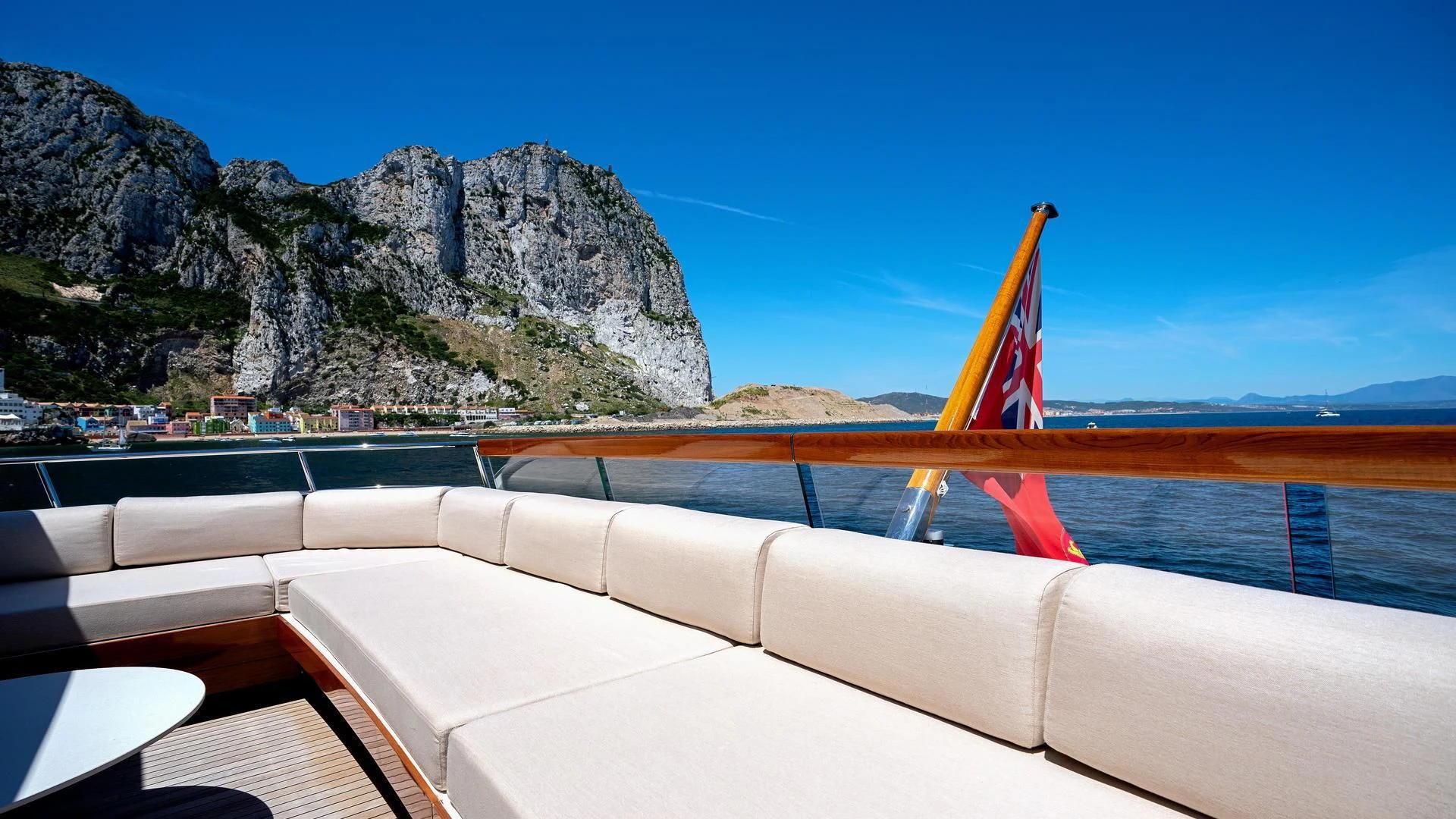 a flag on a railing overlooking a body of water aboard SUPERNOVA Yacht for Sale