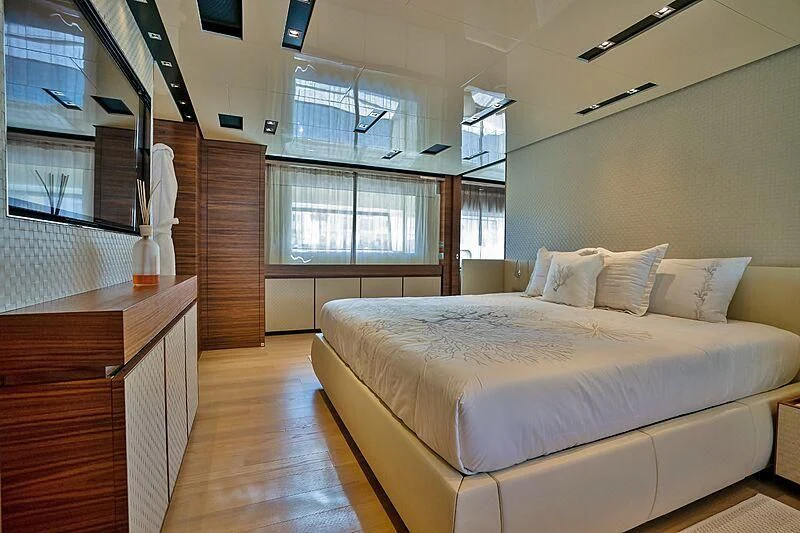 a bedroom with a bed aboard SUPERNOVA Yacht for Sale
