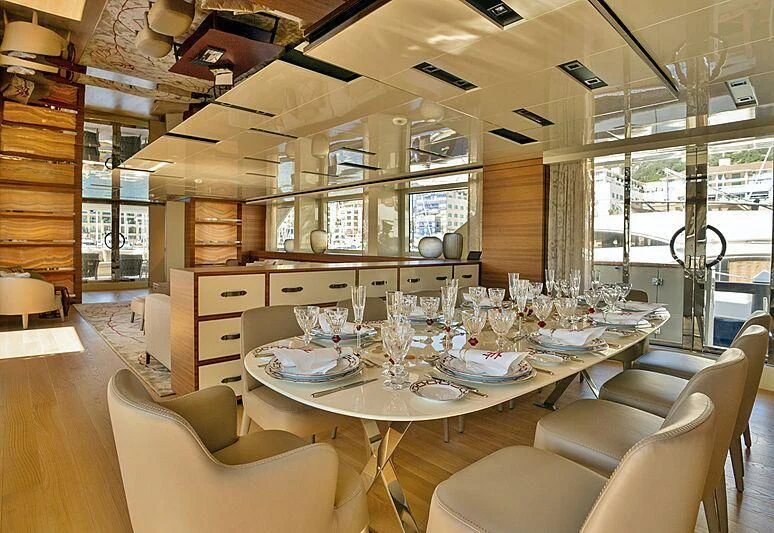 a large kitchen with a dining table aboard SUPERNOVA Yacht for Sale