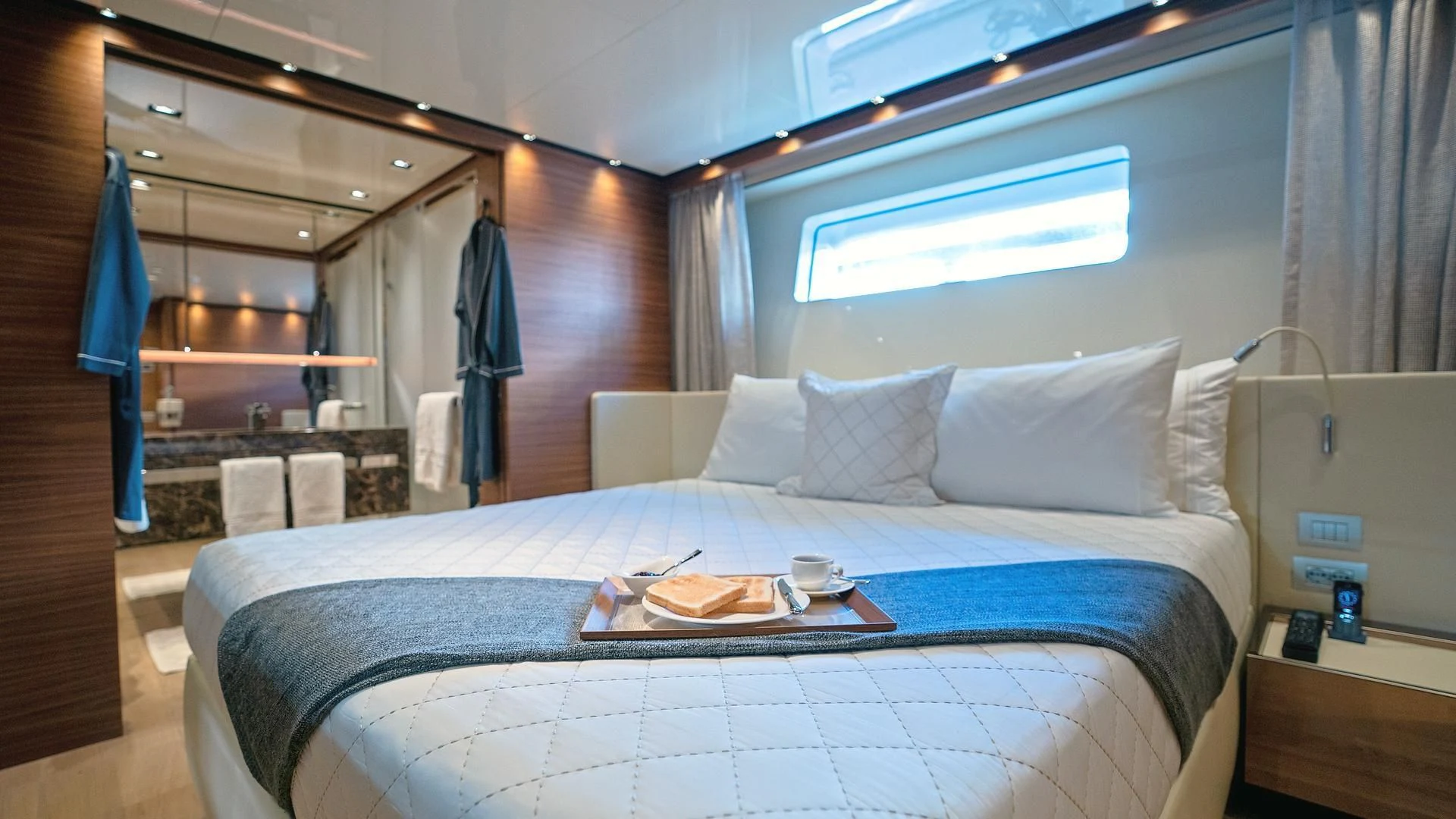 a bed with a blue sheet aboard SUPERNOVA Yacht for Sale