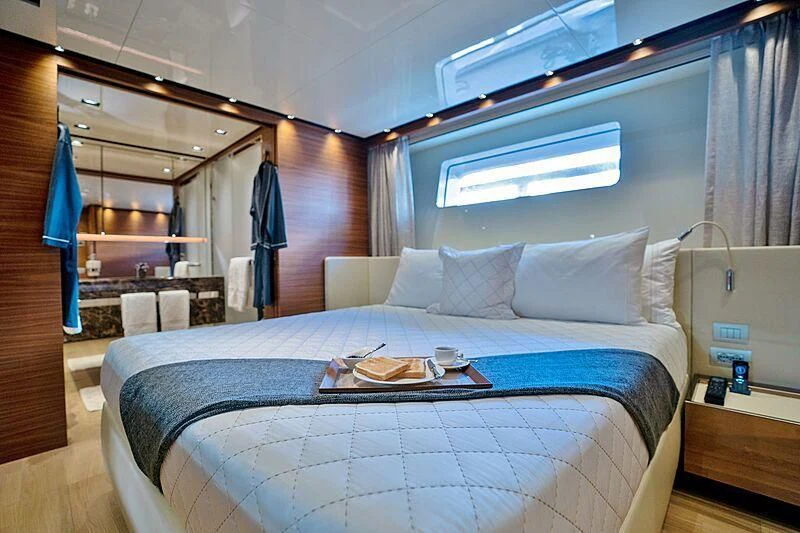 a bed with a blue sheet aboard SUPERNOVA Yacht for Sale