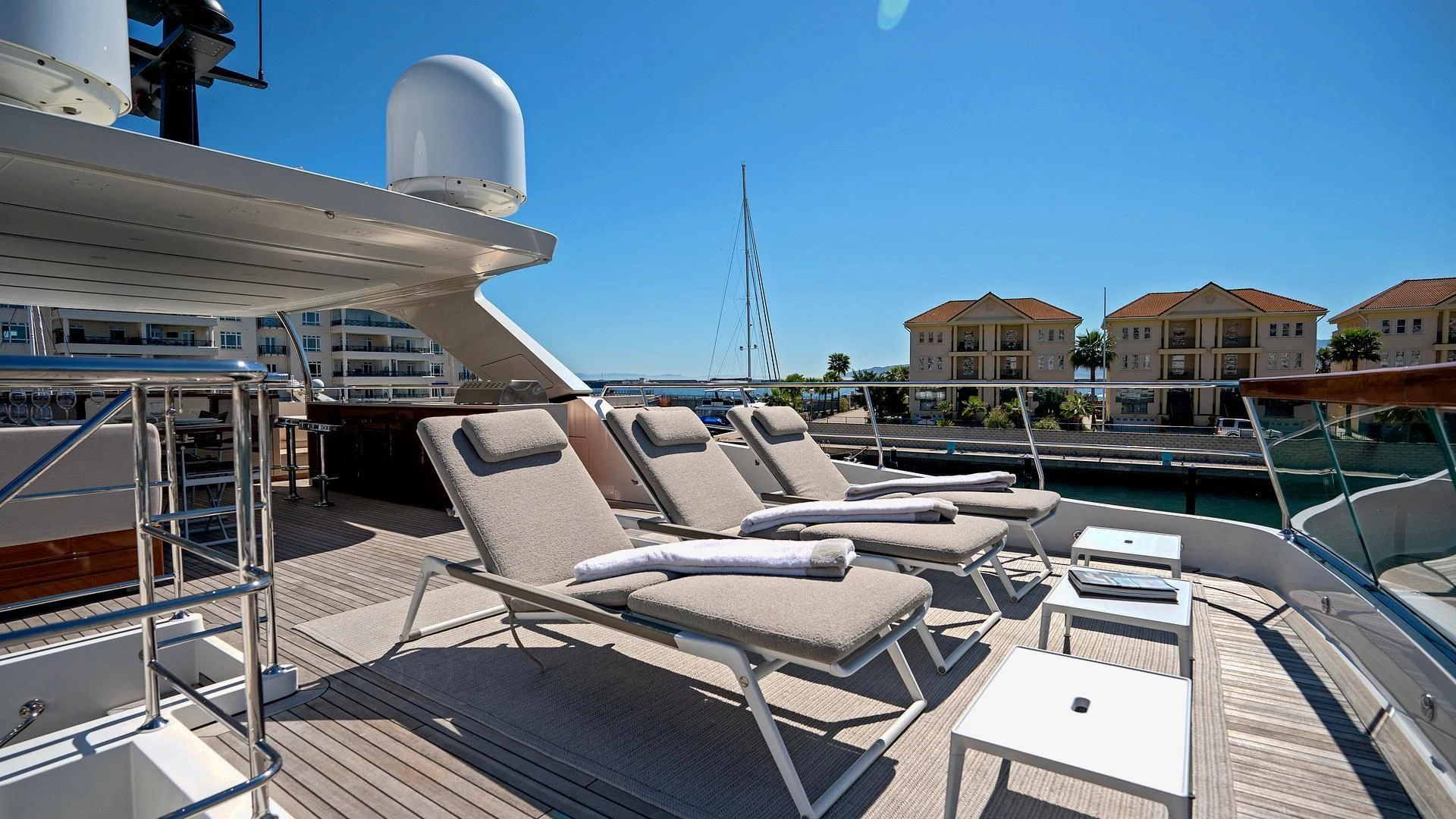 a deck with a large white boat on it aboard SUPERNOVA Yacht for Sale