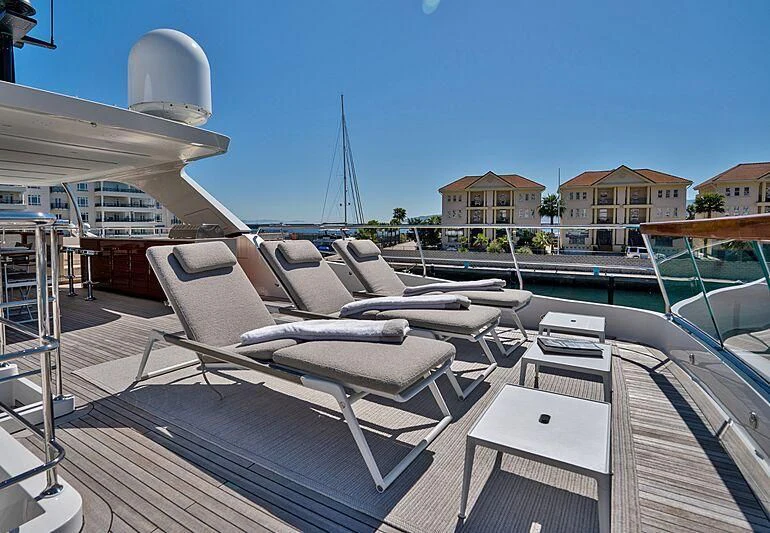 a deck with a deck and a view of the water and boats aboard SUPERNOVA Yacht for Sale