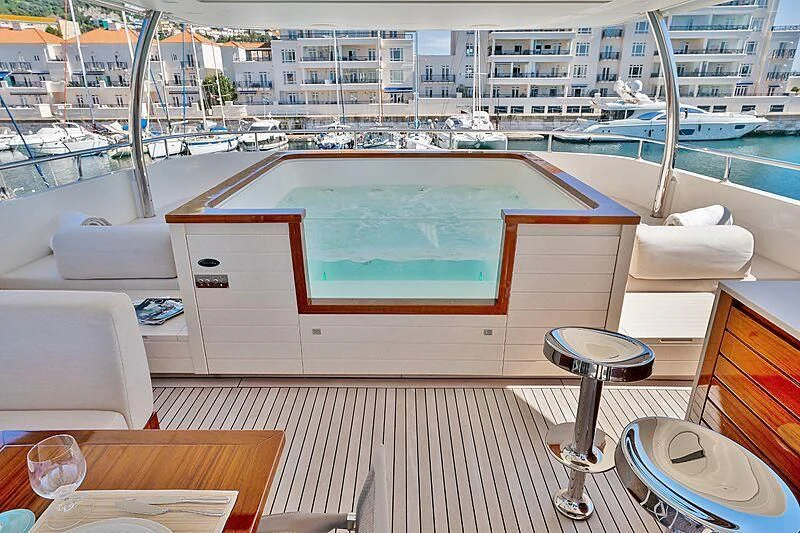 a room with a table and chairs aboard SUPERNOVA Yacht for Sale