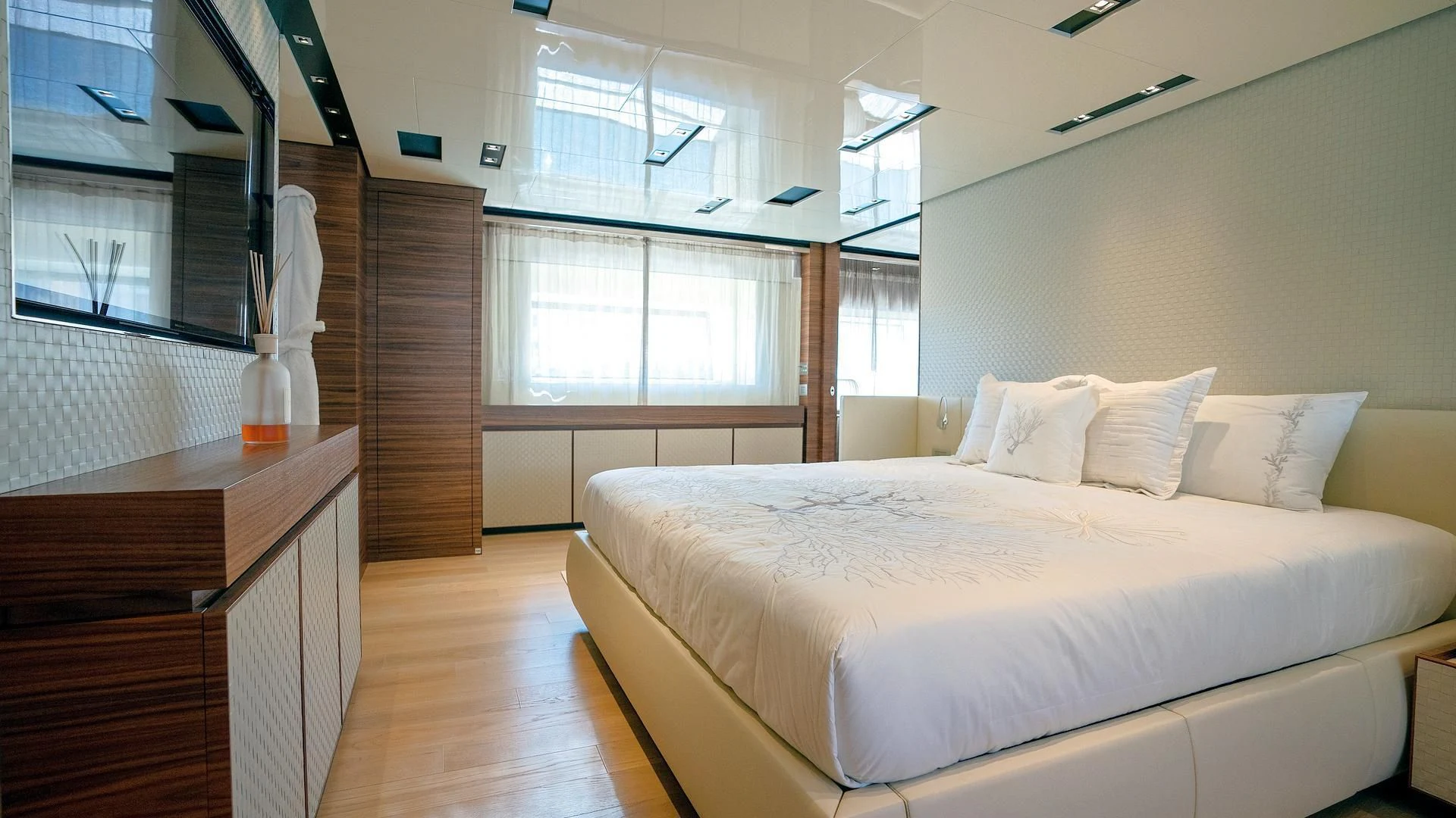 a room with a bed and a window aboard SUPERNOVA Yacht for Sale