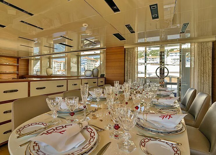 a dining room with a table set aboard SUPERNOVA Yacht for Sale