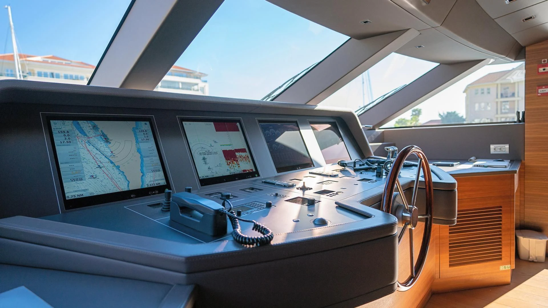 a desk with a laptop and a monitor on it aboard SUPERNOVA Yacht for Sale