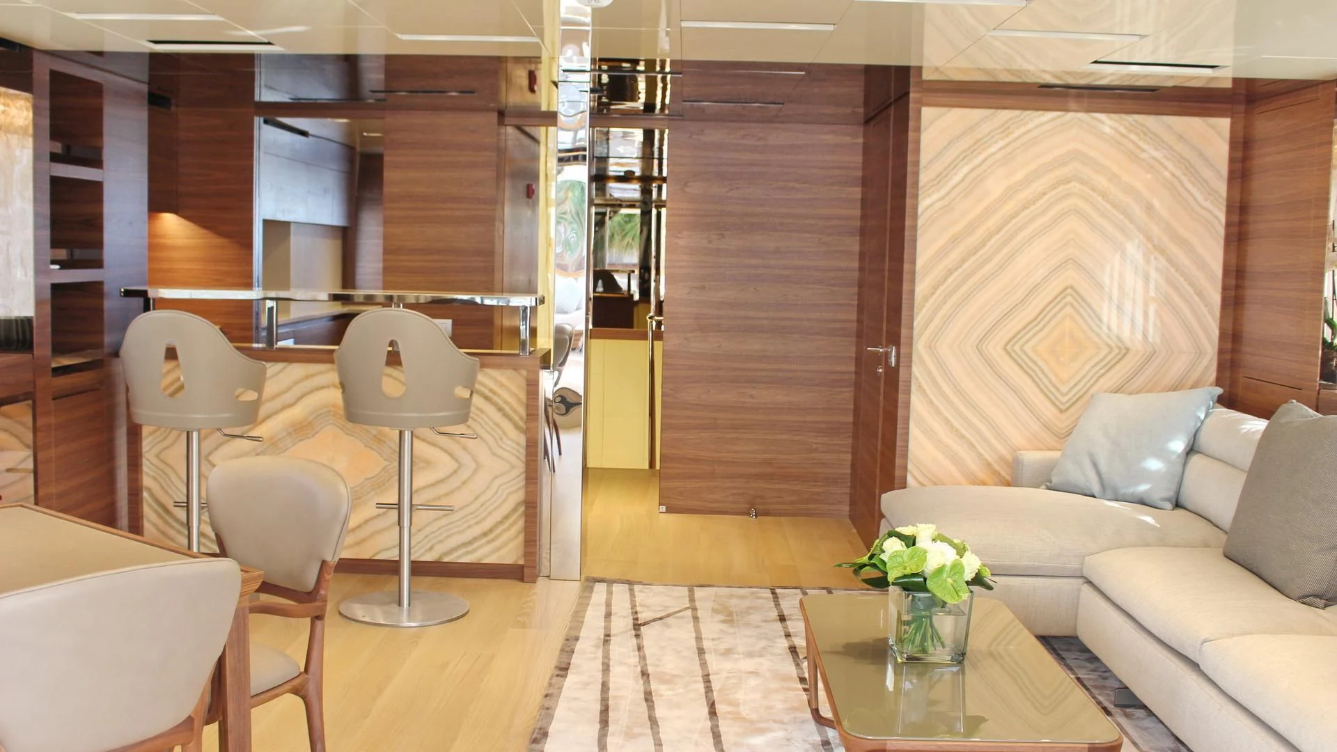 a room with a couch and chairs aboard SUPERNOVA Yacht for Sale