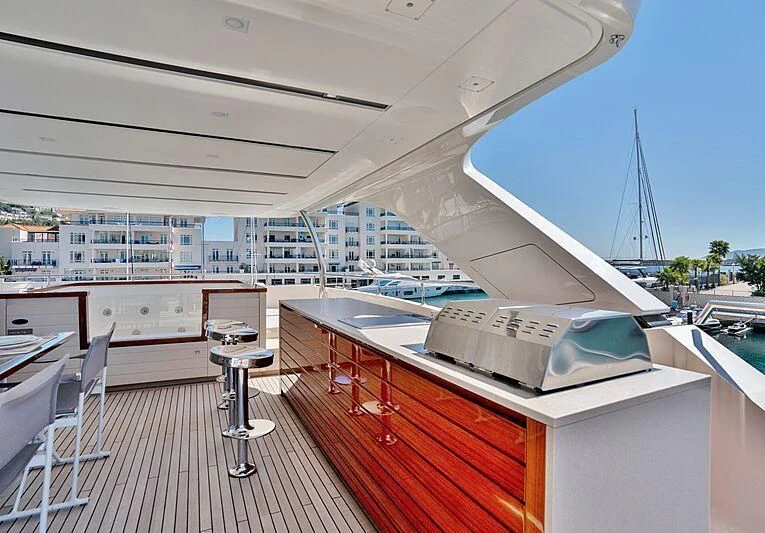 a deck with a large building and a pool aboard SUPERNOVA Yacht for Sale