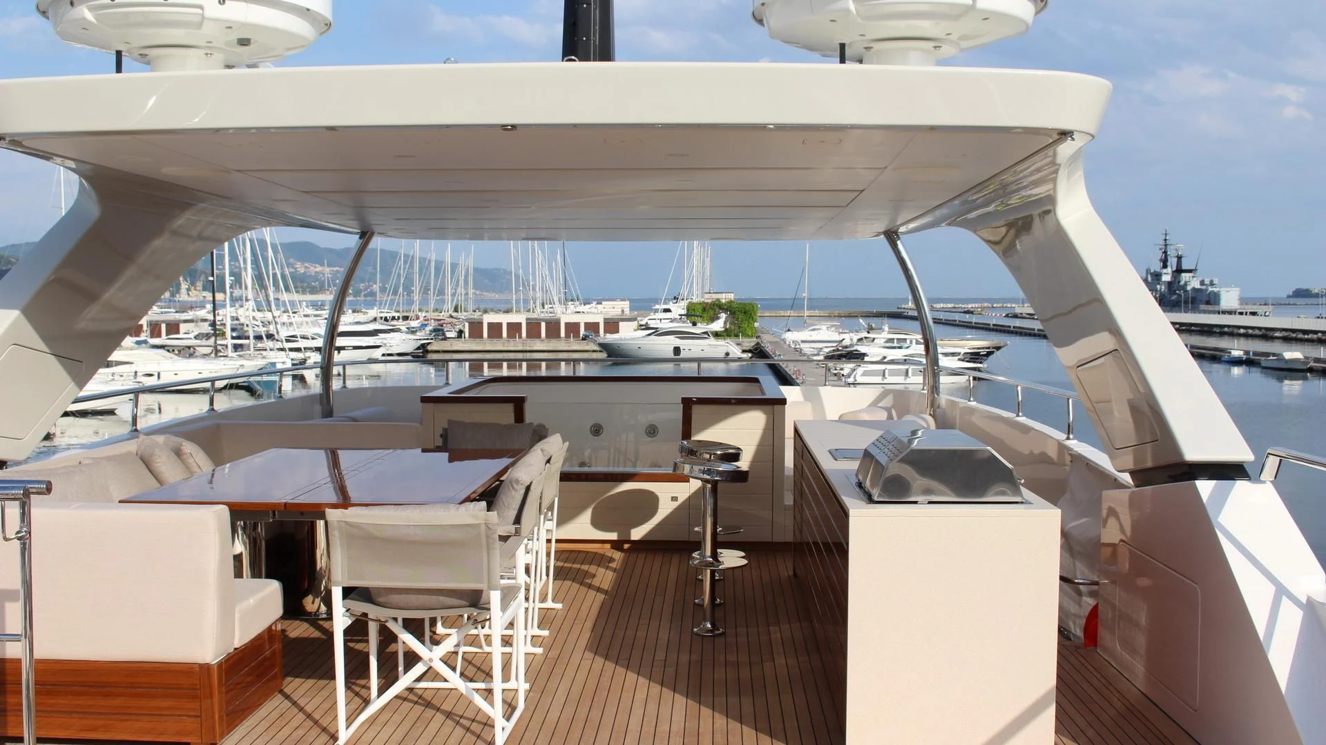 a large white building with a deck and chairs aboard SUPERNOVA Yacht for Sale