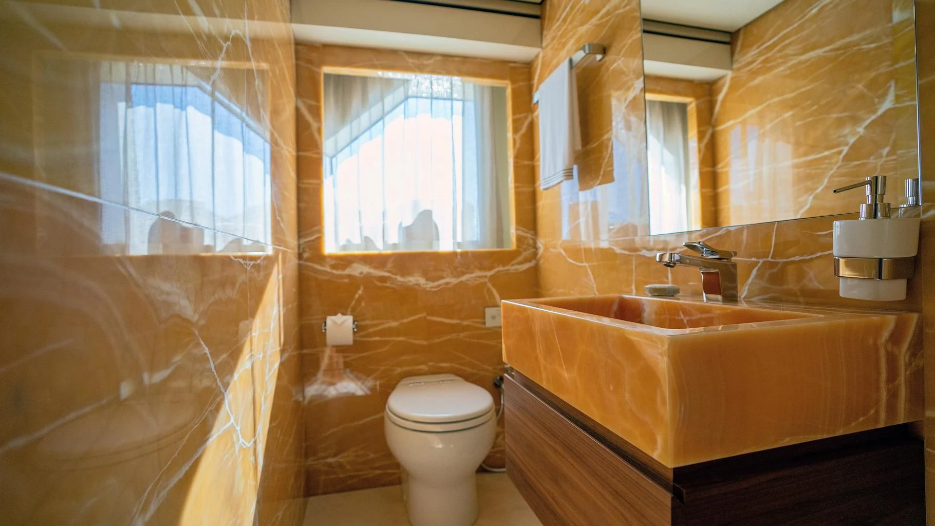 a bathroom with a tub toilet and sink aboard SUPERNOVA Yacht for Sale