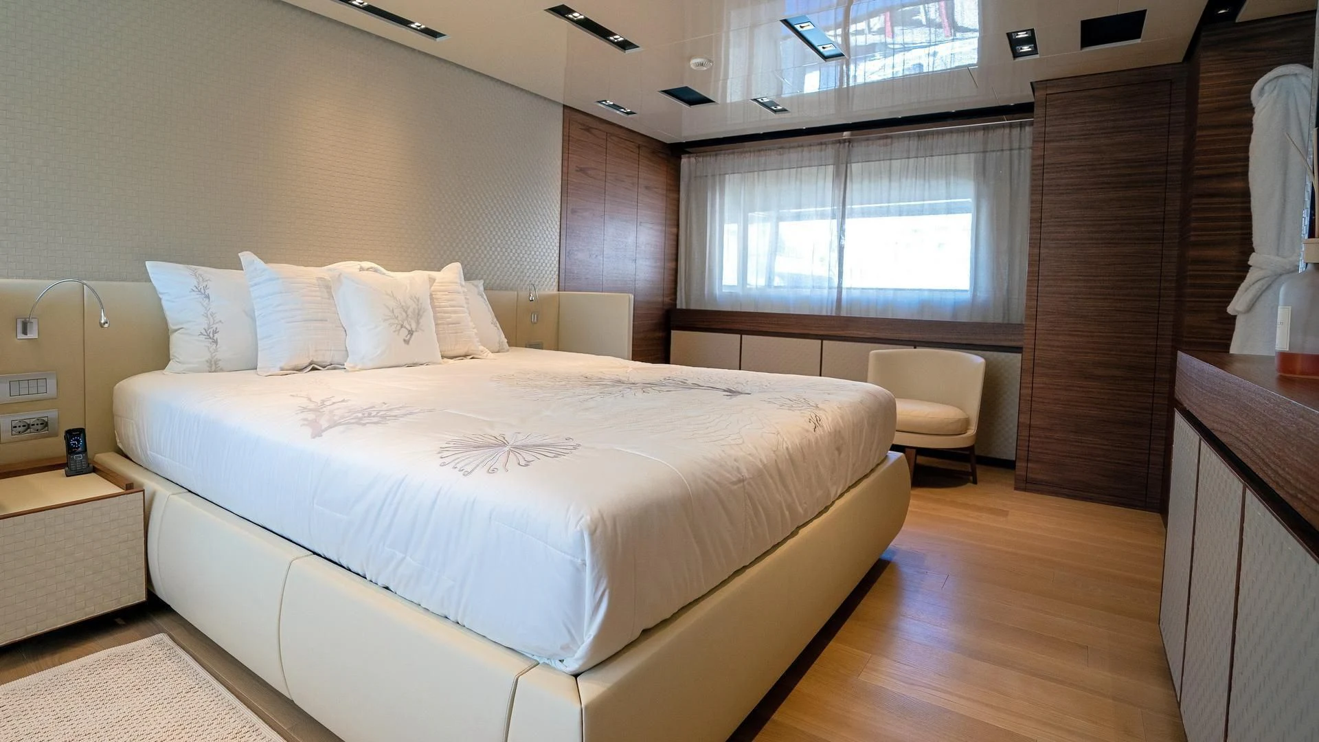 a room with a bed and a chair aboard SUPERNOVA Yacht for Sale