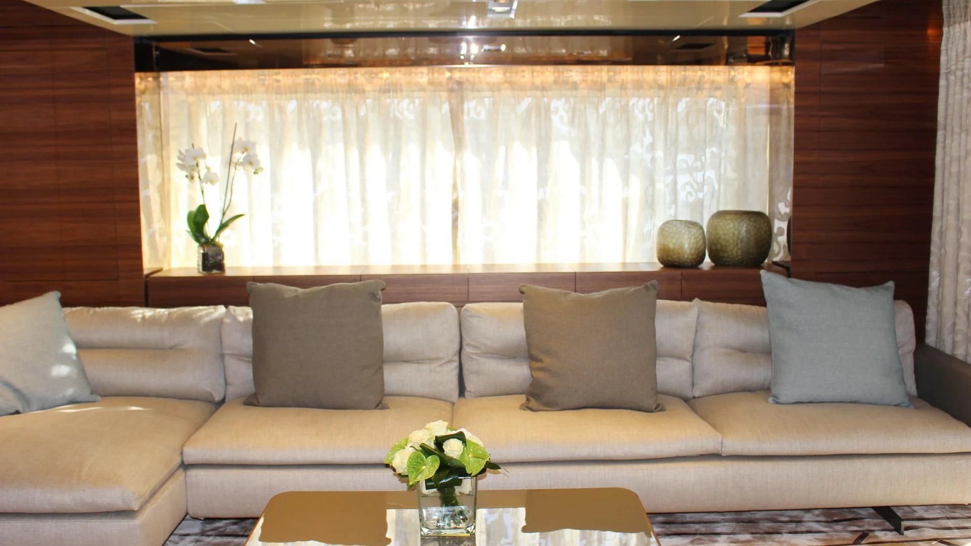 a couch with pillows and a table aboard SUPERNOVA Yacht for Sale