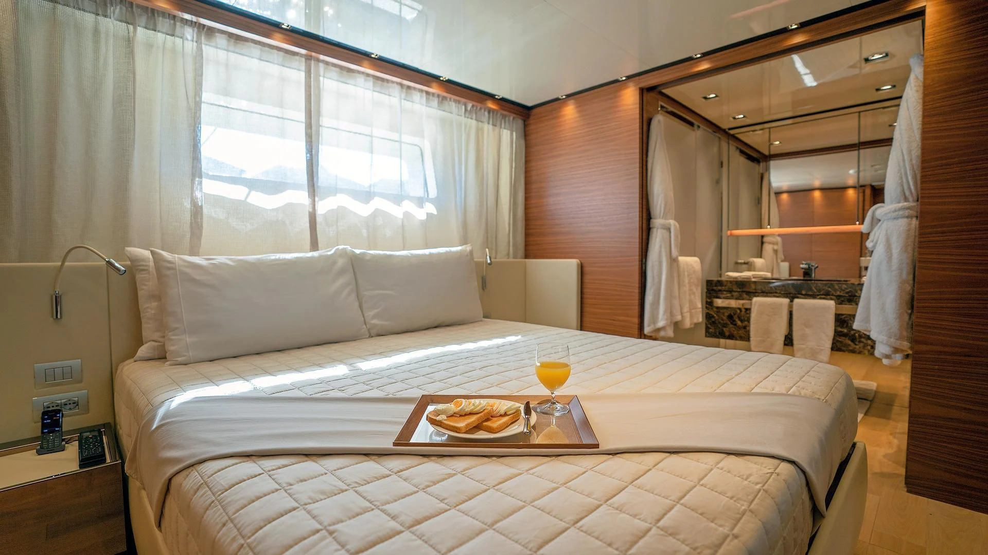 a bed with a table and chairs aboard SUPERNOVA Yacht for Sale