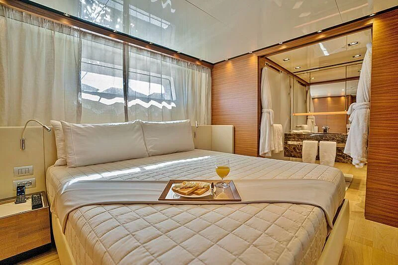 a bed with a tray on it aboard SUPERNOVA Yacht for Sale