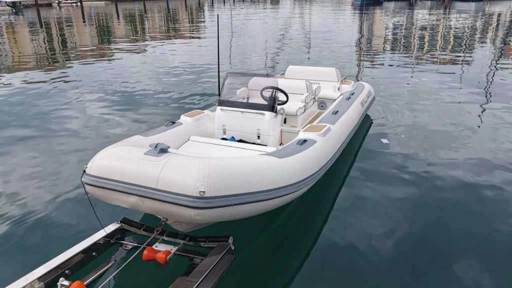 a white boat on the water aboard SUPERNOVA Yacht for Sale